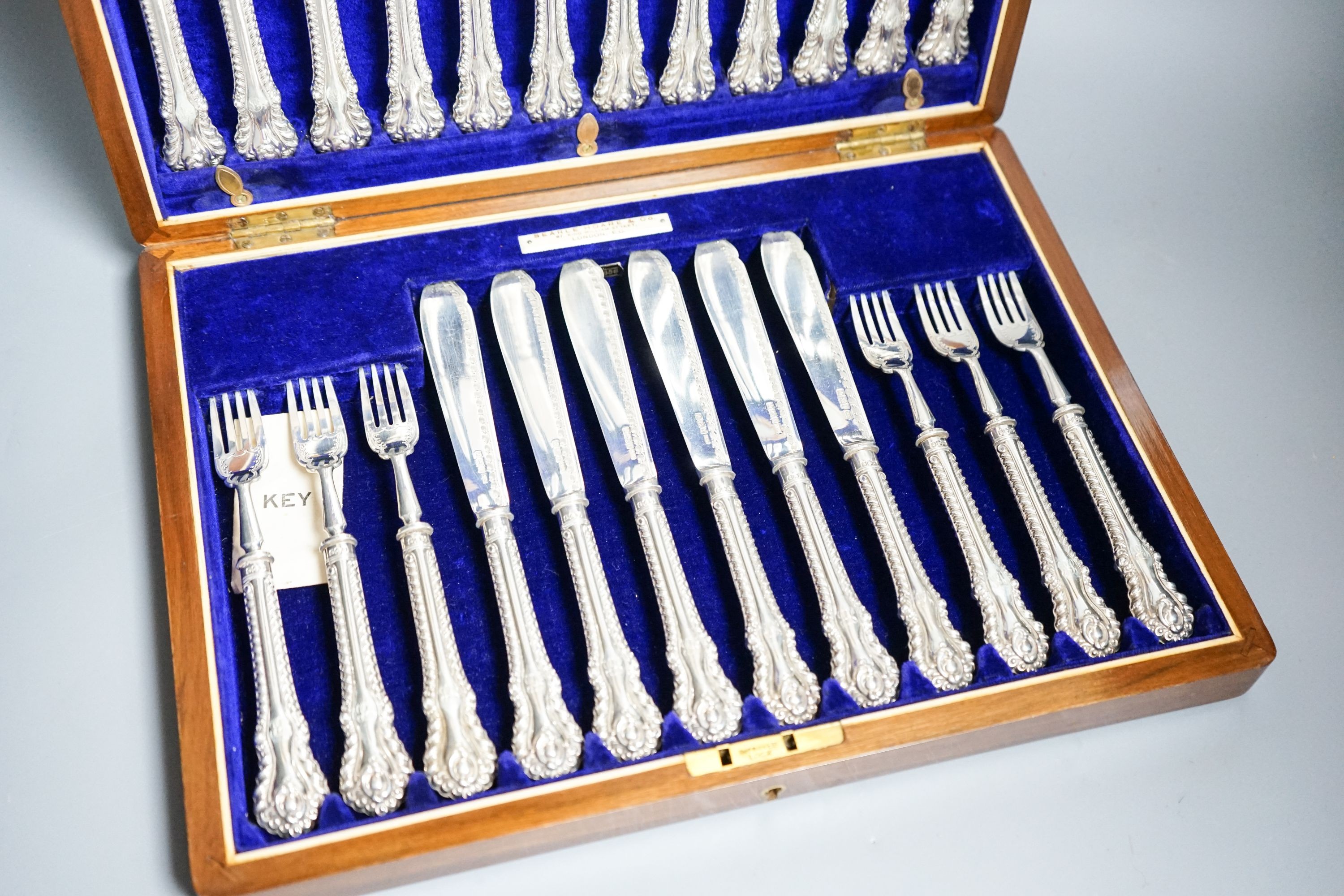 A cased set of twelve pairs of Edwardian silver fish eaters, Allen & Darwin, Sheffield, 1909 (loaded handles)